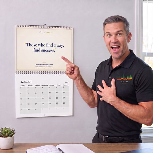 Brian Olson pointing to the 2027 Let's Go Test More ASINs wall calendar, open to August